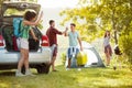 Young couple welcomed their friends join them on a camping trip Royalty Free Stock Photo