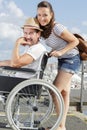 young couple in wheelchair outdoors