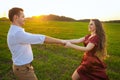 Young couple whirls in field