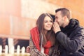 Young couple whispering on an autumn day