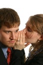 Young Couple whispering at work Royalty Free Stock Photo