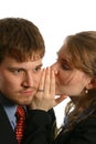 Young Couple whispering at work