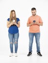 A young couple on a white background looking at the smartphone. Royalty Free Stock Photo