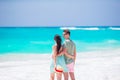 Young couple on white beach during summer vacation. Happy family walking along the ocean Royalty Free Stock Photo