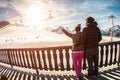 Young couple in winter vacation at snow resort mountain - Skiers tourists relaxing in ski slope chalet - Travel, holiday, Royalty Free Stock Photo