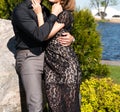 Young couple woman in a long elegant lace black dress man in trousers and shirt. love story outdoors, tenderness, hugs Royalty Free Stock Photo