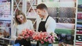 Young couple work at flower shop. Royalty Free Stock Photo