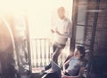 Young couple work together. Photo woman and bearded man working with new startup project in modern loft. Using Royalty Free Stock Photo