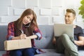 Young couple working at home. Small businesssme concept. Working with modern device technology to contacting to customer from Royalty Free Stock Photo