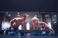 Young couple is working out at gym. Attractive woman and handsom Royalty Free Stock Photo