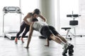 Young couple is working out at gym. Attractive woman and handsome muscular man are training in light modern gym. Double plank. Man Royalty Free Stock Photo