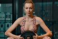 Attractive woman and handsome muscular man are training in light modern gym. Young caucasian white woman doing workout Royalty Free Stock Photo