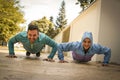 Young couple working pushbuttons on street. Healthy lifestyle.