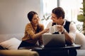 Young Couple Working Together on Computer Laptop in Cafe. Multiethnic Motivated Teamwork Royalty Free Stock Photo