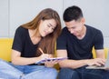 A young couple working together while sitting on a sofa in the office. Business success from work together as a team. Royalty Free Stock Photo