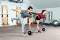 Young Couple Workout Kettlebell Fitness Exercise In The Gym, Selective Focus