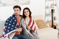 Young couple wrapped in american flag Royalty Free Stock Photo