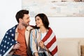 Young couple wrapped in american flag Royalty Free Stock Photo