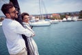 A young couplein a hug is enjoying on the bow of the yacht together while riding on the seaside. Summer, sea, vacation, Royalty Free Stock Photo