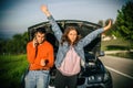 Young couples car broke down on the way. They hitchhike to find help Royalty Free Stock Photo