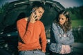 Young couples car broke down on the way. They hitchhike to find help Royalty Free Stock Photo