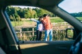 Young couples car broke down on the way. They hitchhike to find help Royalty Free Stock Photo