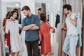 Young Couples in Dressing Room in Modern Boutique. Royalty Free Stock Photo