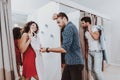 Young Couples in Dressing Room in Modern Boutique. Royalty Free Stock Photo