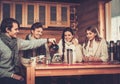 Young couples drinking hot tea in winter cottage Royalty Free Stock Photo