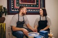 Young couples that enjoy making clay sculptures. Using pottery and assisting one another to create flower vases out of