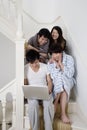 Young couples enjoying while using laptop
