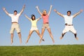 Young couples jumping in air Royalty Free Stock Photo