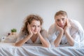 Young couples lie in bed. Royalty Free Stock Photo
