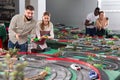 Young couples play a game slot car racing track Royalty Free Stock Photo