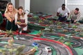 Young couples play a game slot car racing track Royalty Free Stock Photo