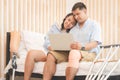 Young couples using laptops in the living room, Women with disability with prosthetic legs sitting relaxing with her husband Royalty Free Stock Photo