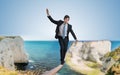 Young courageous businessman is walking on rope Royalty Free Stock Photo