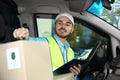 Young courier checking amount of parcels