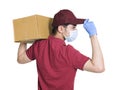 Young couriers wear medical masks  during the covid-19 epidemic. The package is carried on the shoulder, and the hand  touching th Royalty Free Stock Photo