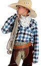 Young cowboy in big hat holding a rope Royalty Free Stock Photo