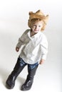 Young cowboy in dad's big boots