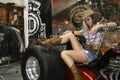 Young cowboy girl posing on a motorcycle