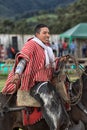 Young cowboy on horse back in Ecuador holding lasso