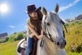 Young cowgirl gallop on white horse Royalty Free Stock Photo