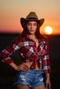 Young cowgirl at sunset