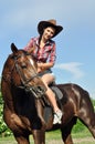 Young cowgirl horseback riding