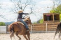 Young cowgirl riding a beautiful paint horse in a barrel racing event at a rodeo. Royalty Free Stock Photo