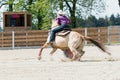 Young cowgirl riding a beautiful paint horse in a barrel racing event at a rodeo. Royalty Free Stock Photo