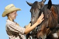 Young cowgirl and two horses Royalty Free Stock Photo