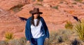 Young cowgirl walking alone through the desert of Nevada